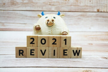 REVIEW 2021 alphabet letter on wooden background