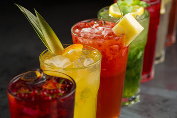 Various summer cocktails on black background