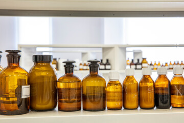 Close up amber color bottles in laboratory. Amber bottle for storing scientific samples.