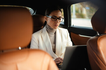 Amazing concentrated business woman sitting in a car