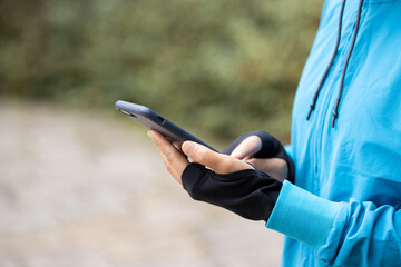 Woman runner using smartphone on trail