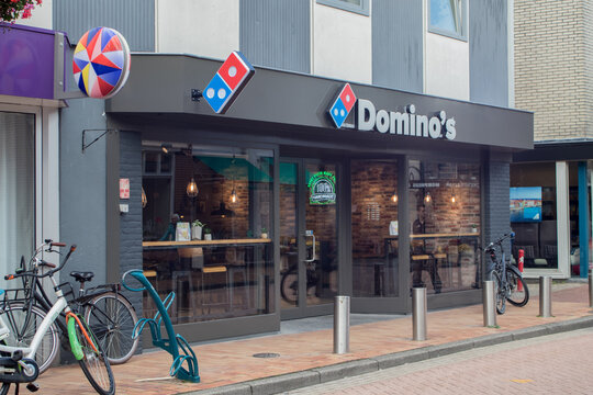 Domino's pizza delivery restaurant branch exterior with delivery bikes parked outside