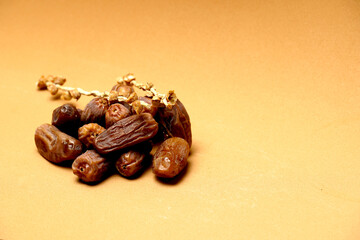 dates on branch on flat brown background. organic food concept