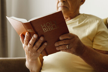 Elderly man reading holy bible