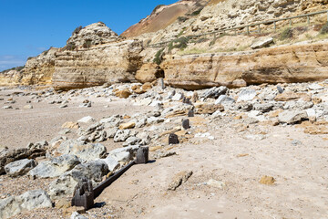 The eroded jetty posts with the limsetone cliffs in the background at Port Willunga South Australia on December 8th 2020