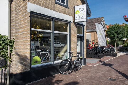 Small bicycle shop building showing shop window, entrance and sign