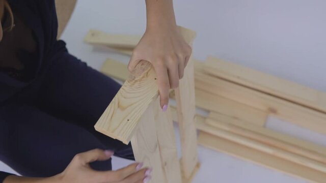 Woman self-assembly collects shelving. Close-up