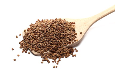 Buckwheat seed pile with wooden spoon isolated on white background