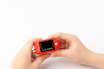 Pulse Oximeter, finger digital device to measure oxygen saturation in blood. Coronavirus symptoms concept.