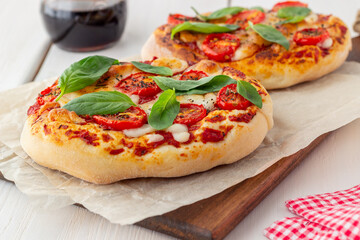Italian focaccia or pizza with mozzarella, tomatoes and basil. Healthy eating. Vegetarian food.