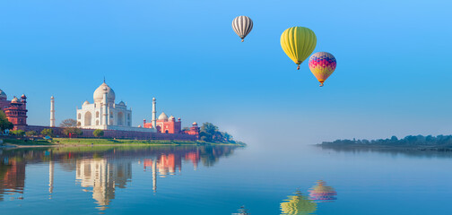 Hot air balloon flying over Taj-Mahal - Taj Mahal mausoleum reflected in Yamuna river - Agra, Uttar...