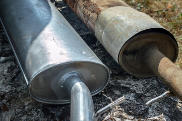 There are old and new exhaust pipes nearby. Repair, replacement of the exhaust system in used cars....