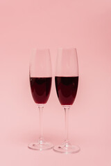 red wine in glasses isolated on pink