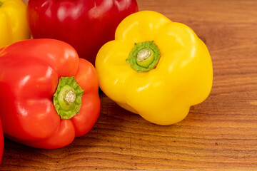 Close up of peppers on a brown wooden kitchen table