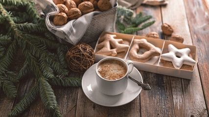 Food banner. Hot flavored nutty cappuccino with caramel and gingerbread Christmas cookies on a rustic table.