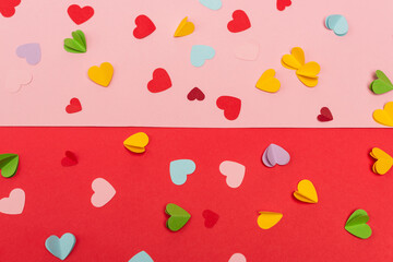 top view of colorful paper hearts on red and pink background