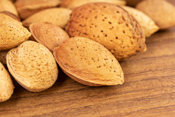 Close up of almonds on a brown wooden kitchen table