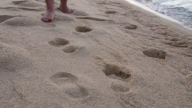 Young man walk on sand sea beach. Relaxation in tropical. Bare feet