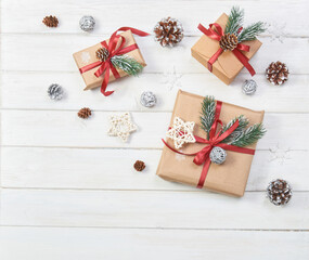 Christmas gifts boxes on a white wooden background with decor.
