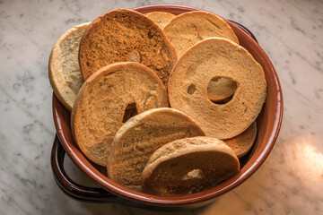 friselle in earthenware pot, typical Italian  donut shaped bread made with durum wheat flour and toasted in the oven