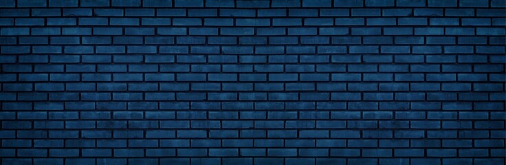 Navy blue brick wall wide texture. Dark block masonry large widescreen background. Gloomy night indigo backdrop