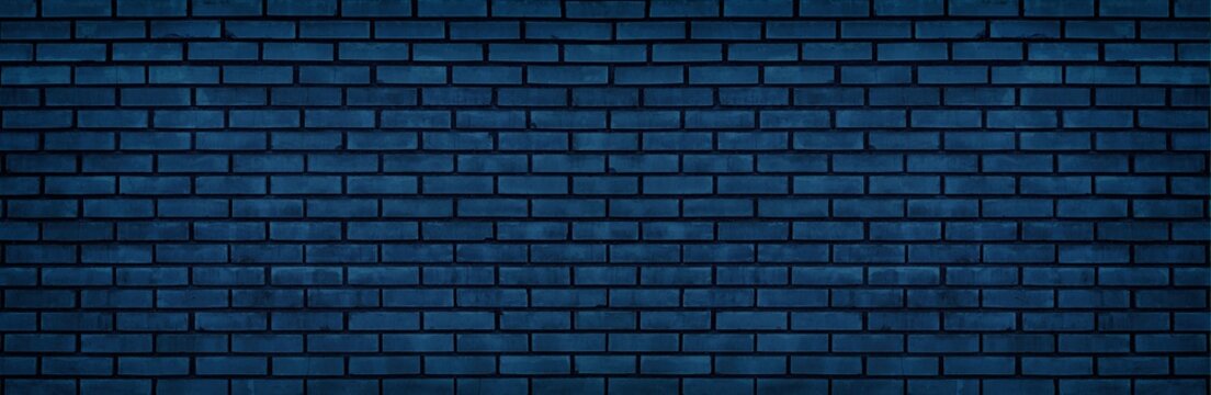 Navy blue brick wall wide texture. Dark block masonry large widescreen background. Gloomy night indigo backdrop