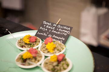 Finger food Quinoa Bowl with pink and yellow humus on a plate