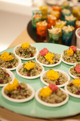 Finger food Quinoa Bowl with pink and yellow humus on a plate