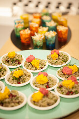 Finger food Quinoa Bowl with pink and yellow humus on a plate