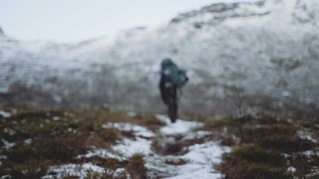 Hiker With Backpack Walking Snowy Trail