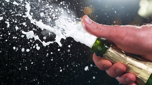Champagne popping, detail of bottle with wine explosion