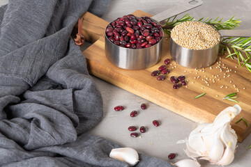 Raw white quinoa seeds (lat. Chenopodium quinoa), red beens, garlic and rosemary. Gluten free Healthy food. Diet, dieting concept