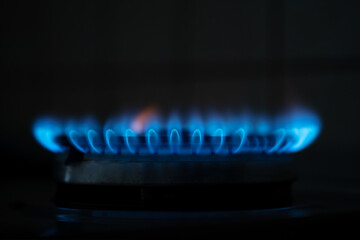 Blue flame gas in the dark. Gas switching on. Natural gas close up