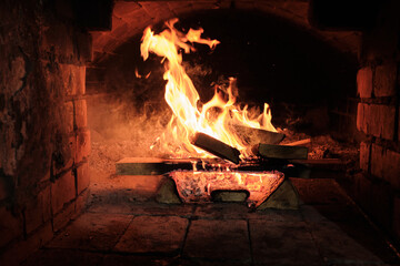 Russian stove with wood burning in it. Defocus .
