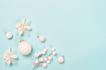 Christmas copmosition with white holidays decorations. Flat lay image on blue background.