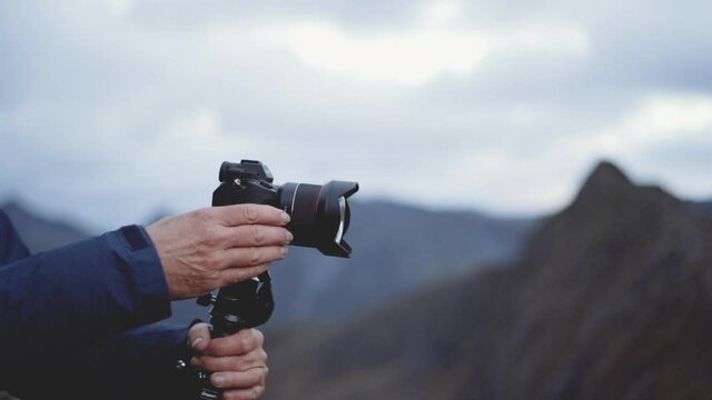 Photographer Focusing Camera In Landscape