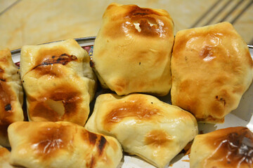 fresh baked buns under bright light on the plate for sale