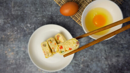 Selective focused Omelet, egg roll with vegetables and ham.