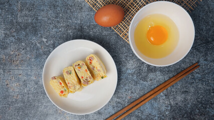Omelet, egg roll with vegetables and ham.
