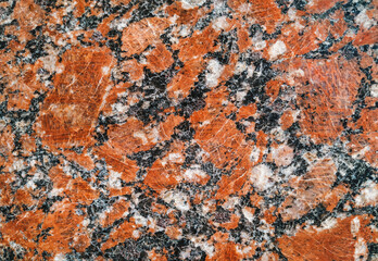 Grunge background from old red granite natural stone texture. Polished surface, copy space.
