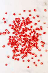 Pomegranate seeds on a white background