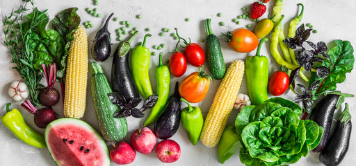 Fototapeta na wymiar Food banner. Garden organic vegetables, berries, fruits on a light background, top view. Healthy diet vegetarian food concept. Flat lay