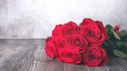 Red rose flowers bouquet on shelf in front of stone wall - 398030067