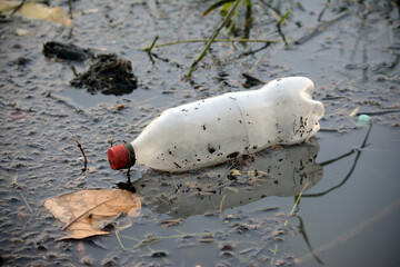  Plastic bottle floating in the water of a lake.