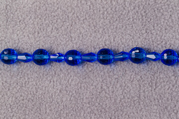 a stand of oval blue beads for the creation of jewelry