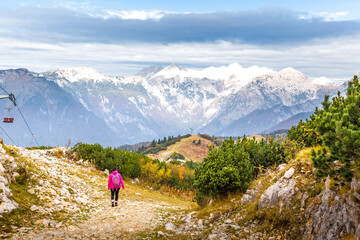 Naklejka na ściany i meble Woman walking hiking Velika Planina mountain, Slovenia.