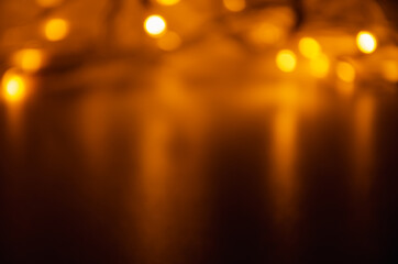 Abstract golden bokeh lights glowing on dark background