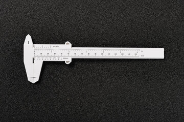 plastic caliper for children on black background