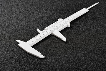 plastic caliper for children on black background