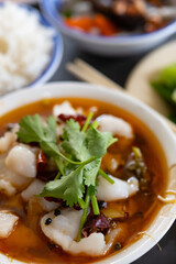 angle view fast food of spicy boiled fish and vegetable and peanuts and lotus and carrots and fungus vertical composition